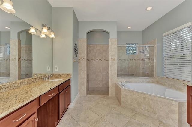 bathroom featuring vanity, tile patterned floors, and separate shower and tub