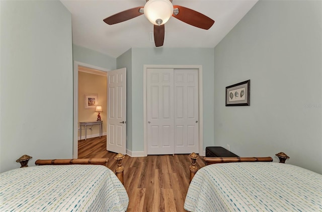 bedroom with wood-type flooring, a closet, and ceiling fan