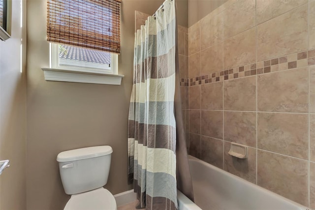 bathroom with shower / tub combo with curtain and toilet