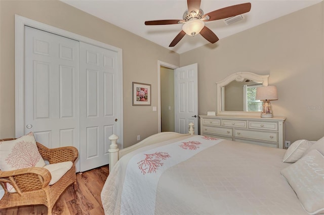 bedroom featuring light wood-type flooring, ceiling fan, and a closet