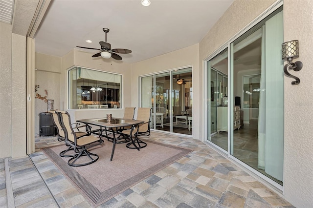 sunroom / solarium featuring ceiling fan