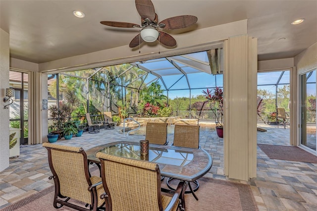 view of patio / terrace featuring ceiling fan and a lanai