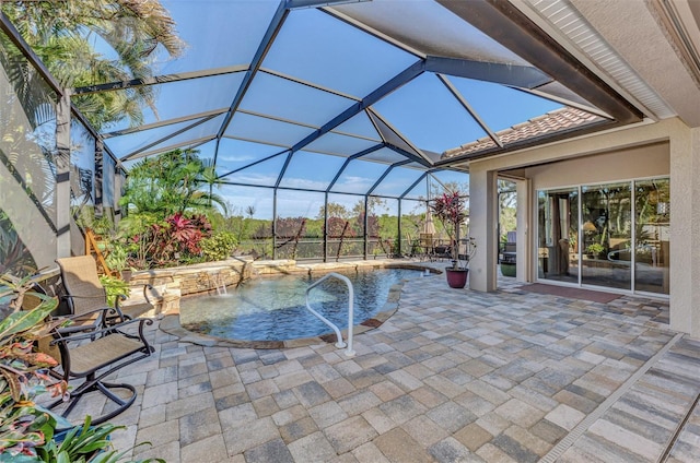 view of pool with a patio area, pool water feature, and glass enclosure