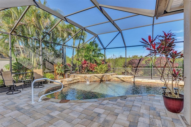 view of swimming pool featuring a hot tub, pool water feature, glass enclosure, and a patio area