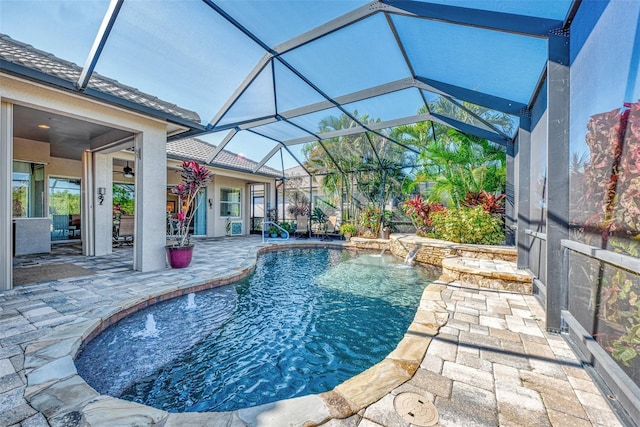 view of swimming pool with a lanai, a patio area, pool water feature, and ceiling fan