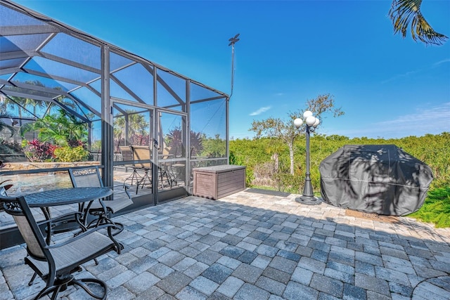 view of patio featuring glass enclosure