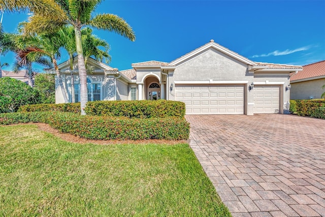 view of front of home with a garage and a front lawn