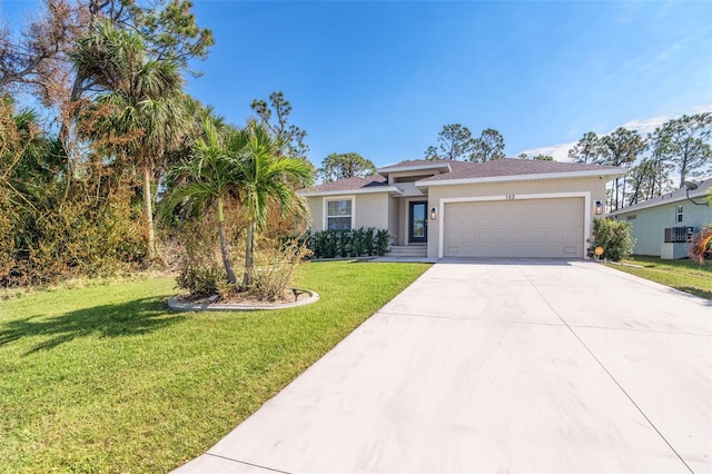 152 Apollo Dr, Rotonda West, FL 33947 - view of front facade with stucco siding, an attached garage, driveway, and a front lawn