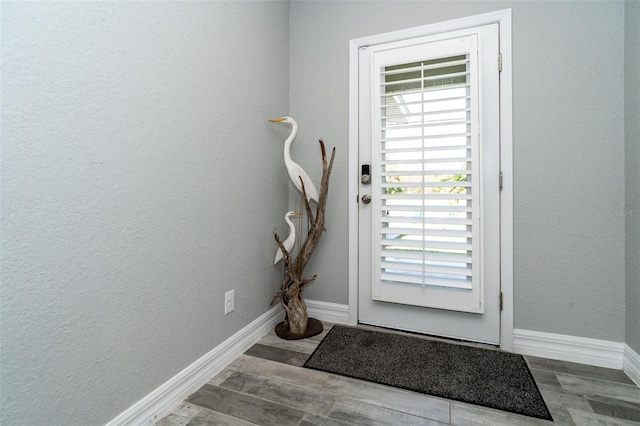 152 Apollo Dr, Rotonda West, FL 33947 - entryway featuring plenty of natural light, baseboards, wood finished floors, and a textured wall