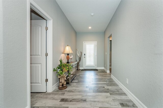 152 Apollo Dr, Rotonda West, FL 33947 - corridor with wood finished floors, baseboards, a textured wall, and recessed lighting