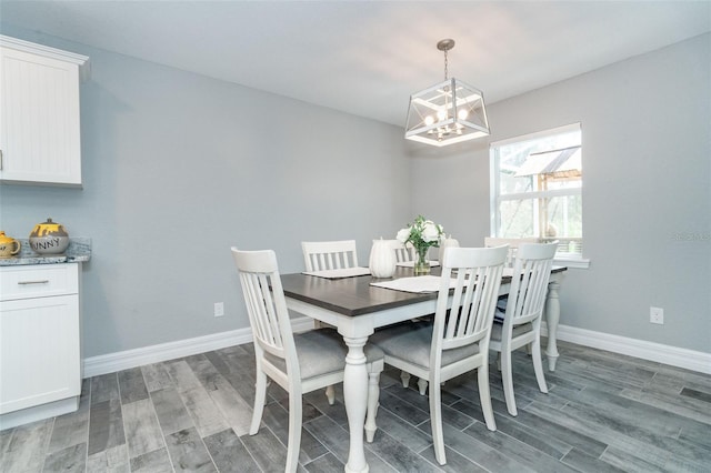 dining room with hardwood / wood-style flooring and an inviting chandelier