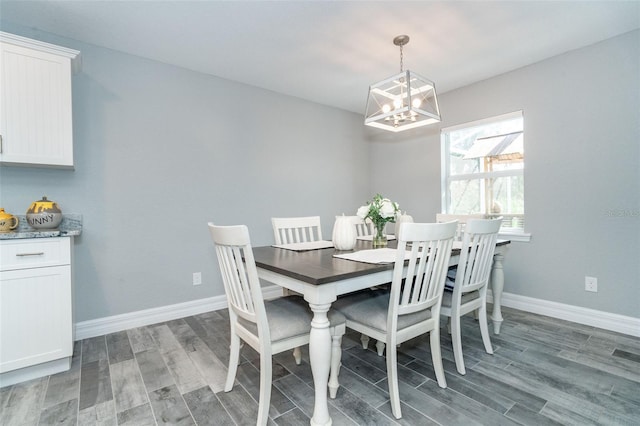 152 Apollo Dr, Rotonda West, FL 33947 - dining space featuring wood finished floors, a chandelier, and baseboards