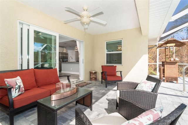 view of patio with an outdoor hangout area, sink, and ceiling fan