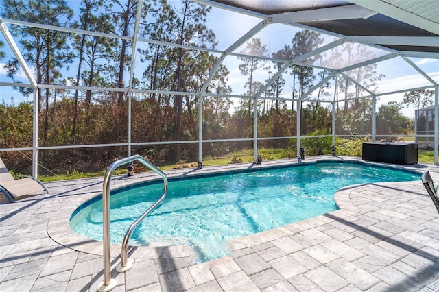 view of swimming pool with a patio area and a lanai