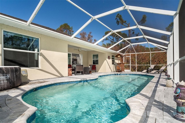 view of swimming pool featuring a lanai, ceiling fan, and a patio