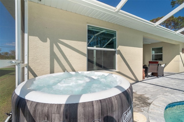 view of patio / terrace with a hot tub