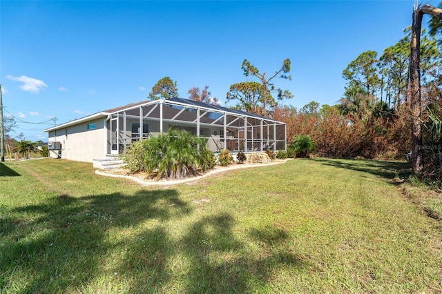 152 Apollo Dr, Rotonda West, FL 33947 - view of green lawn featuring glass enclosure