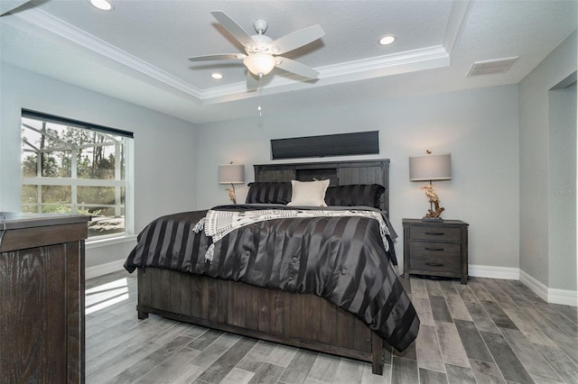 152 Apollo Dr, Rotonda West, FL 33947 - bedroom featuring a tray ceiling, baseboards, wood finished floors, crown molding, and recessed lighting