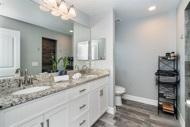 152 Apollo Dr, Rotonda West, FL 33947 - full bath with a shower, toilet, wood finished floors, double vanity, and baseboards