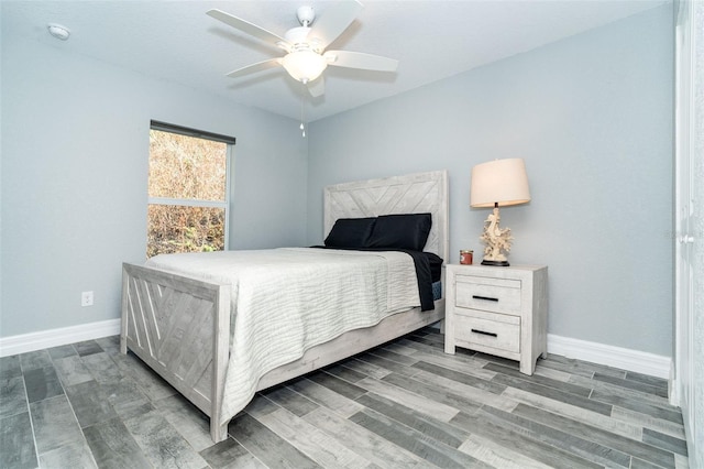 152 Apollo Dr, Rotonda West, FL 33947 - bedroom featuring baseboards, wood finished floors, and a ceiling fan