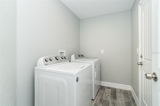 152 Apollo Dr, Rotonda West, FL 33947 - clothes washing area with washer and dryer, wood finished floors, and baseboards