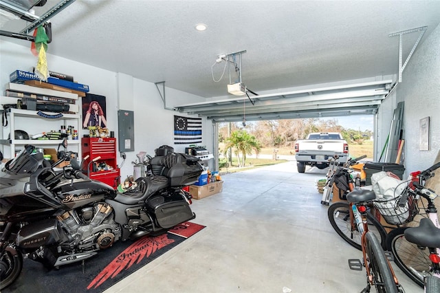 garage with electric panel and a garage door opener