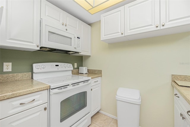 kitchen featuring white cabinetry, light tile patterned floors, and white appliances