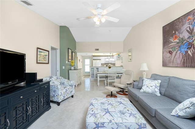 living room featuring ceiling fan, light carpet, and vaulted ceiling