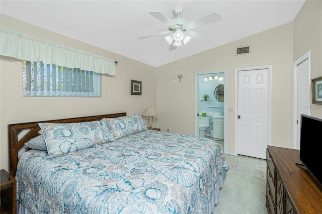 carpeted bedroom featuring ceiling fan, ensuite bathroom, and vaulted ceiling