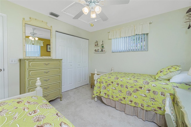 carpeted bedroom with ceiling fan and a closet