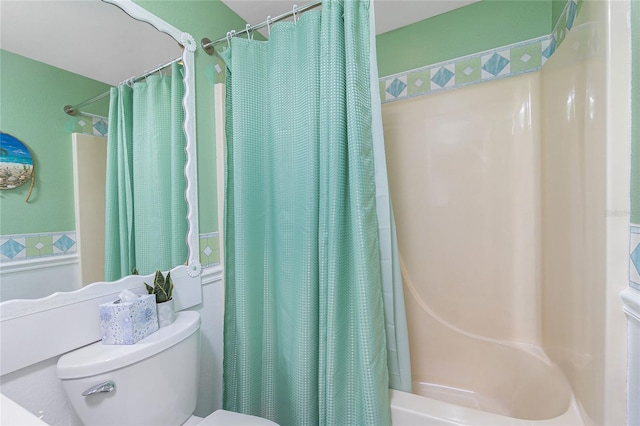 bathroom featuring shower / bath combo and toilet