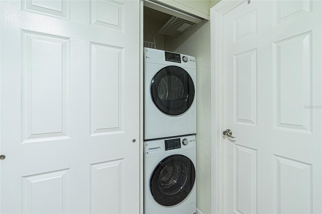 washroom with stacked washer and dryer