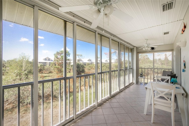 sunroom with ceiling fan and a healthy amount of sunlight