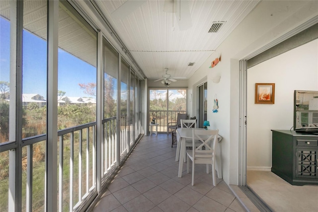 sunroom featuring ceiling fan