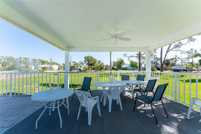 deck with ceiling fan and a yard