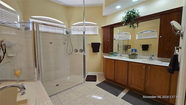 bathroom with vanity, an enclosed shower, and tile patterned floors