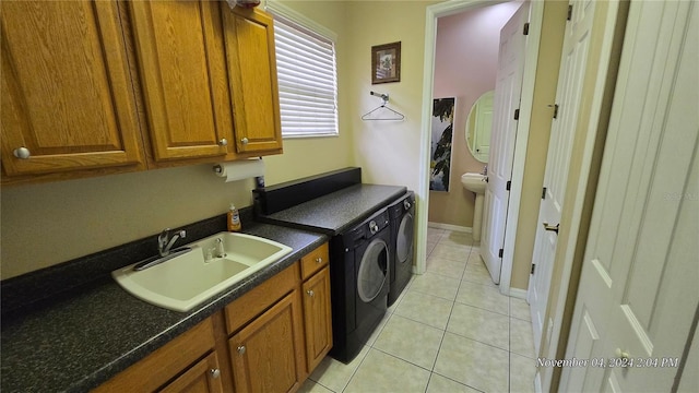 washroom featuring cabinets, separate washer and dryer, sink, and light tile patterned floors