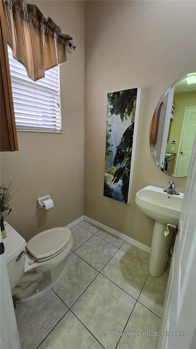 bathroom featuring toilet and tile patterned flooring