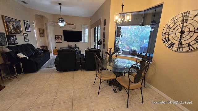 tiled dining space featuring ceiling fan with notable chandelier