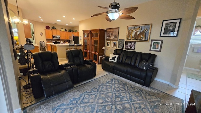 living room featuring ceiling fan with notable chandelier and light tile patterned flooring