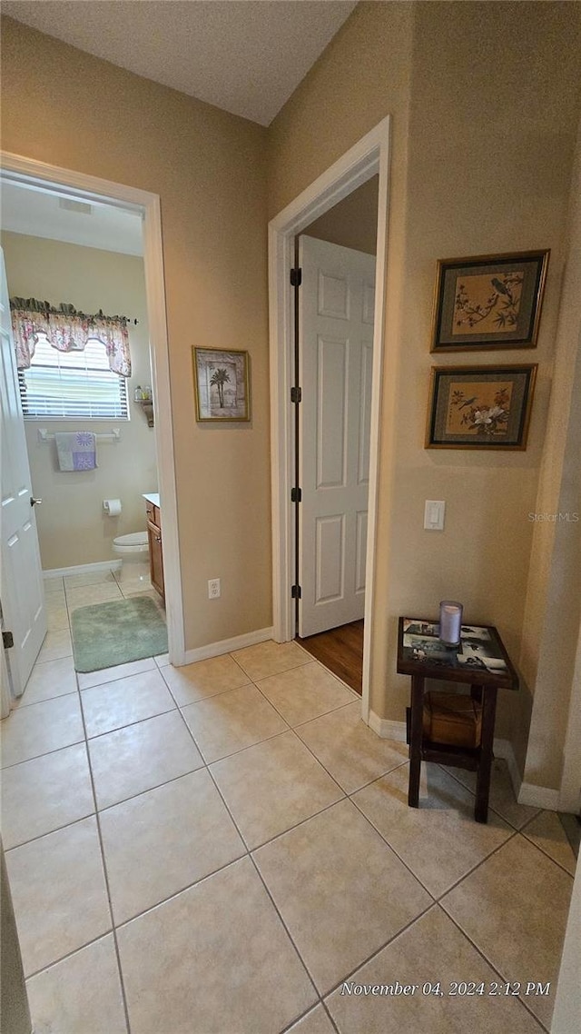 corridor featuring light tile patterned flooring