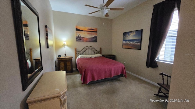 bedroom with lofted ceiling, ceiling fan, and carpet floors