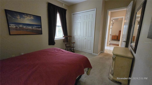 bedroom featuring a closet and light carpet