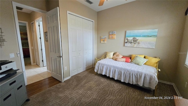 bedroom with hardwood / wood-style flooring, ceiling fan, and a closet