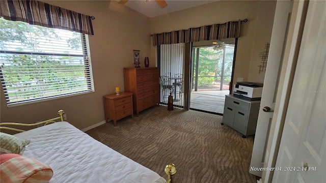 bedroom featuring dark colored carpet, ceiling fan, and access to exterior