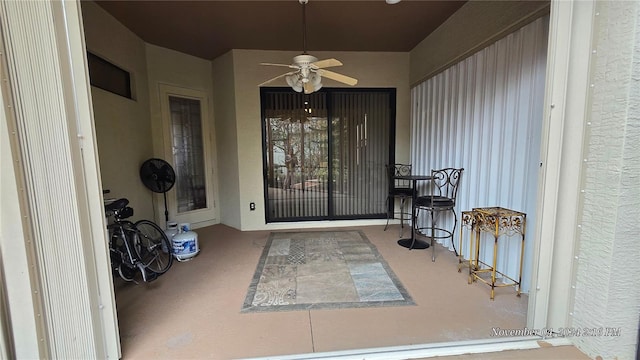 property entrance with ceiling fan