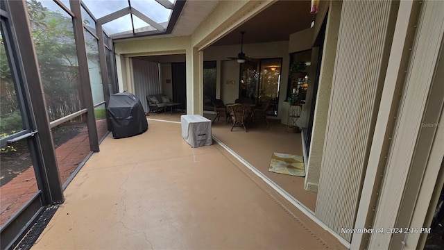 unfurnished sunroom with a skylight and ceiling fan