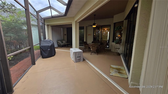 sunroom with lofted ceiling with skylight and ceiling fan