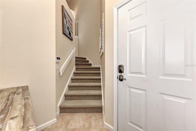 staircase with tile patterned floors