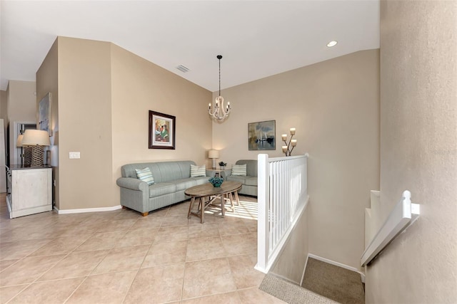 living room with a chandelier and light tile patterned floors